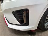 a close up of a white car with red rims