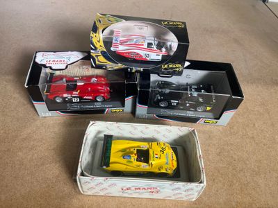 three toy cars in boxes on the floor next to each other