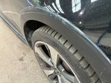 a close up of a car ' s tire on the street