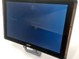 the tablet is sitting on a stand with a blue screen