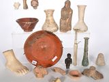 many different types of pottery on display on the table