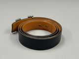 a close up of a black and brown belt on a white surface