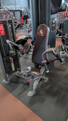 a gym with a lot of machines in the room