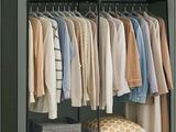 an image of a closet with clothes on hangers