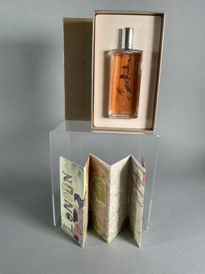 a bottle of perfume sitting in a box on a table