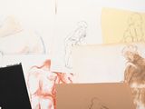 many drawings of a man and a woman on a table