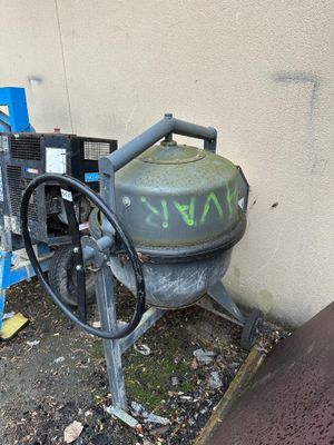 a machine that has graffiti on it next to a building
