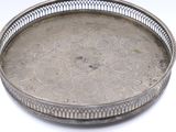 a silver tray with a decorative design on it