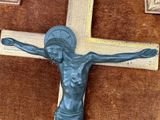 a statue of jesus on a cross on a brown background