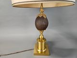 a lamp that is sitting on a table with a lamp shade on it