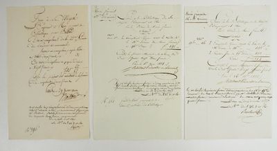 three pieces of paper with writing on them sitting on a table