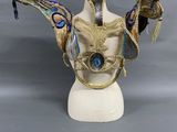 an image of a mannequin head with feathers and beads on it
