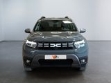 the front view of a grey suv parked in a showroom