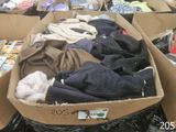 a box full of clothes that is sitting on the floor