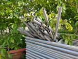a pile of metal pipes sitting in a planter