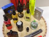 many different types of perfumes sitting on a tray