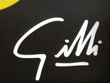 a close up of a black and yellow sign with a banana on it