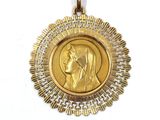 a close up of a gold medal on a white background