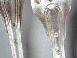 two forks that are sitting next to each other