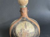 an old bottle with a picture of a church on it
