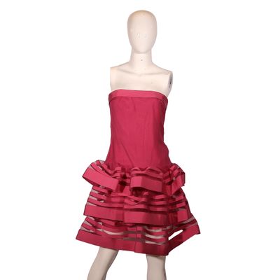 the mannequin is wearing a red dress with ruffles on it