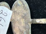 a silver spoon with a piece of paper attached to it