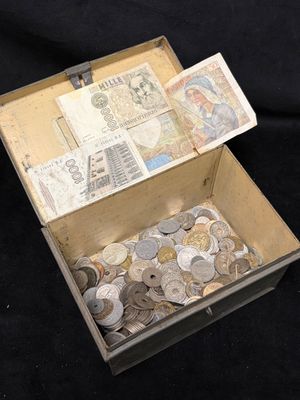 a box full of coins sitting on a black surface