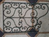 a decorative iron gate on the floor of a building
