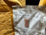 a label on the back of a jacket with a picture on it