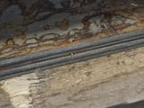 a close up of a piece of wood with rust on it