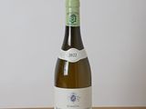 a bottle of wine sitting on a wooden table