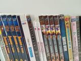 many dvds lined up on a shelf in a row