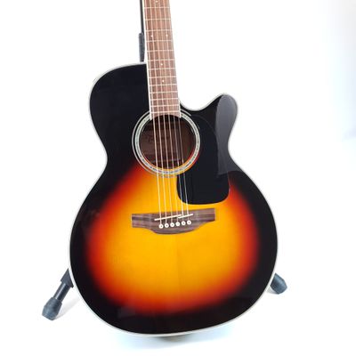 an acoustic guitar sitting on top of a stand on a white surface