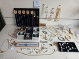 a lot of jewelry sitting on a table in a room