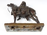 bronze statue of a man on a horse with a man on a horse
