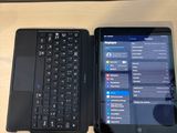a laptop and a tablet sitting on a table next to each other