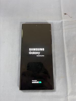 a picture of a black samsung phone on a white surface