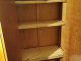 a wooden cabinet with a door open on the floor