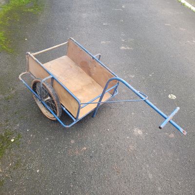 a cart with a wooden box on the back of it