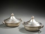 pair of silverplated dishes with handles and handles on a table