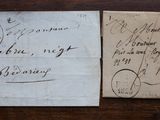 an old envelope with a stamp on it sitting on top of a wooden table