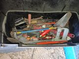 a bin full of tools that are sitting on the ground
