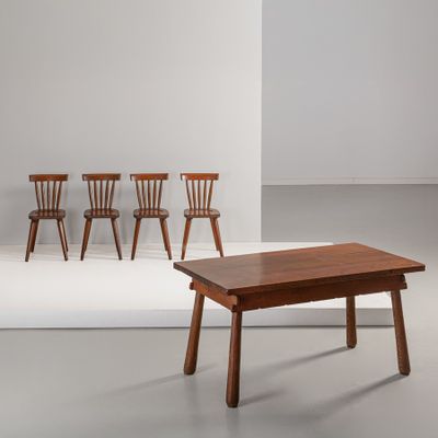 trois chaises et une table dans une pièce aux murs blancs