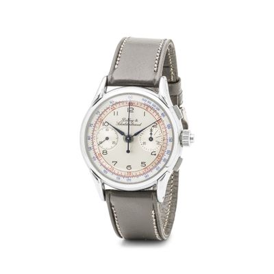 une photo d'une montre-bracelet avec un cadran blanc et un bracelet en cuir marron