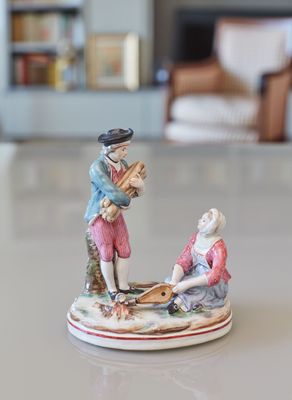 a figurine of a man and a woman sitting on a boat
