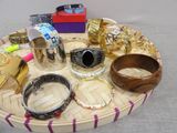 many different types of bracelets and bangles on a tray