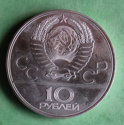 a silver coin with a picture of a bird on it