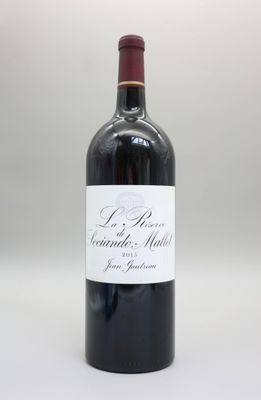 la bouteille de vin rouge est posée sur une surface blanche