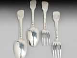 four silver spoons and a fork are sitting next to each other