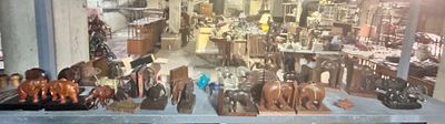 a lot of wooden statues on display in a store
